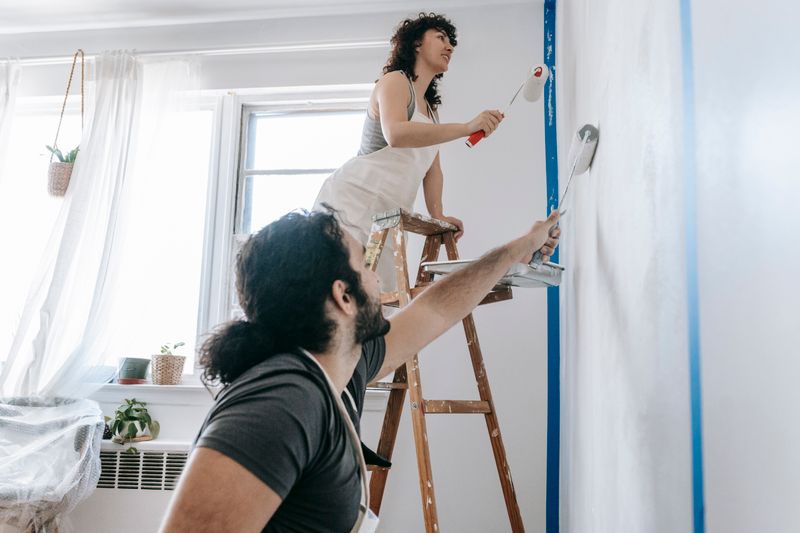 a couple painting their wall
